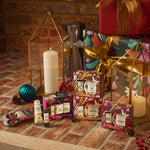 Gifts and decorative items on a brick surface with candles and ornaments.