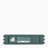 Green rectangular package with labels on a white background