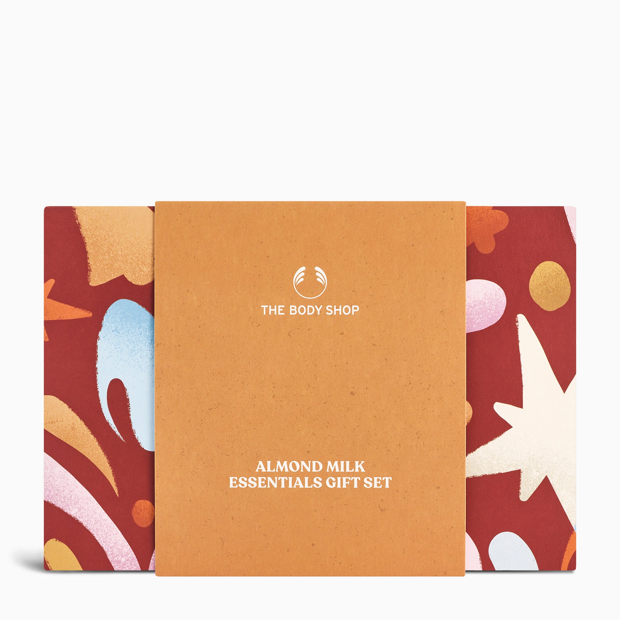 Gift set packaging for 'Almond Milk Essentials' by The Body Shop with a colorful design on a white background.
