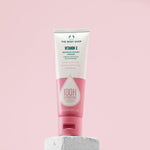 Tube of The Body Shop Vitamin E Barrier Boost Cream on a pink background