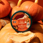 Jar of Sugar Pumpkin body scrub with pumpkins in the background