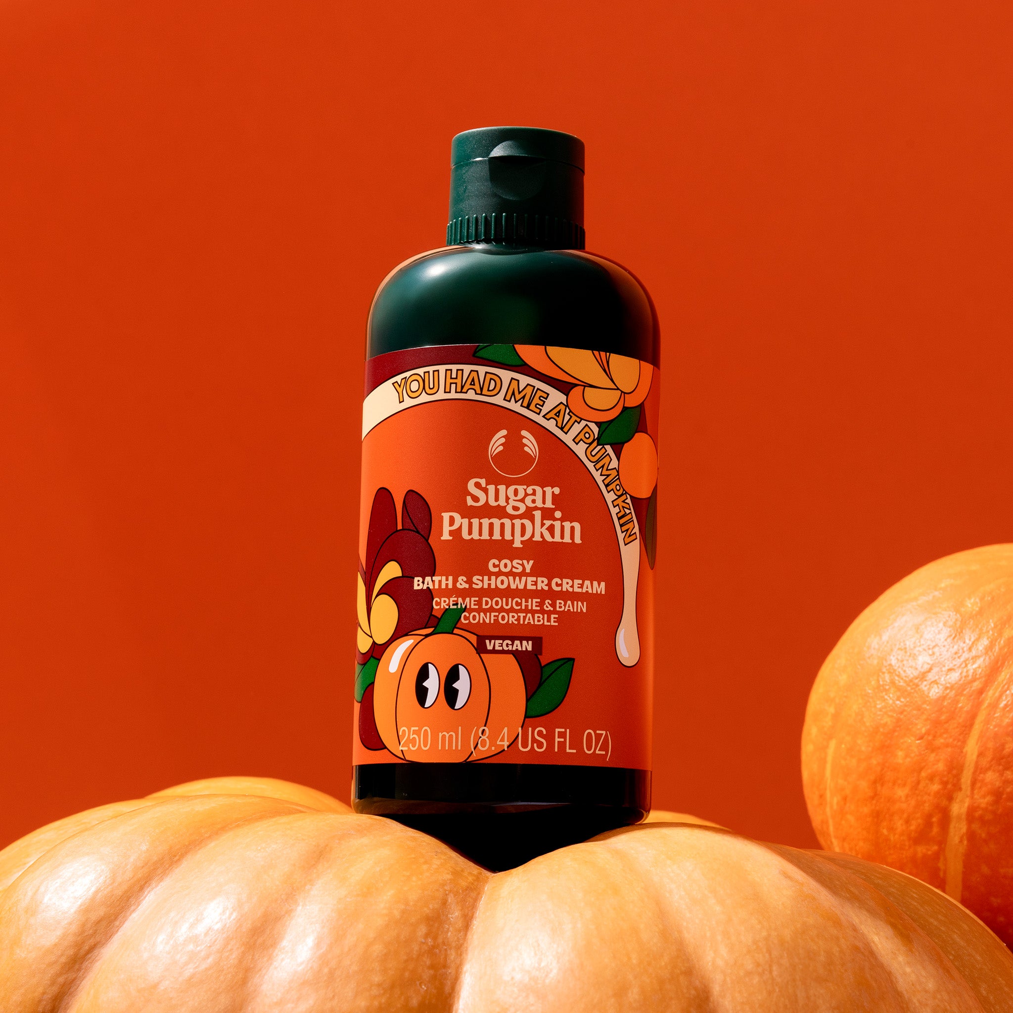 Bottle of 'You Had Me at Pumpkin' soap on pumpkins with an orange background