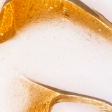 Close-up of a gold leaf design on a white background