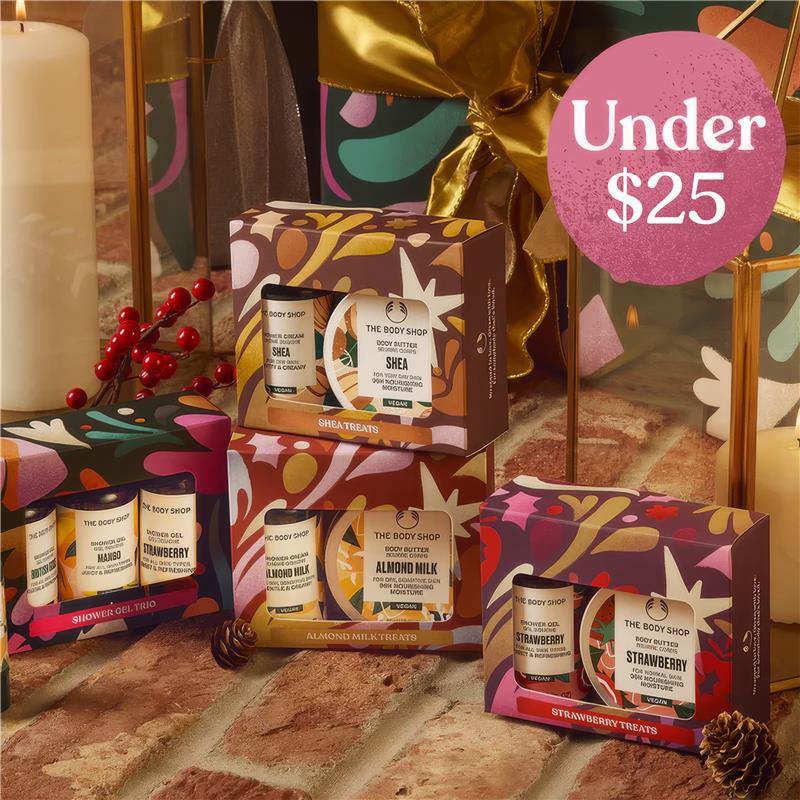 The Body Shop gift sets with products and decorative elements on a textured surface.