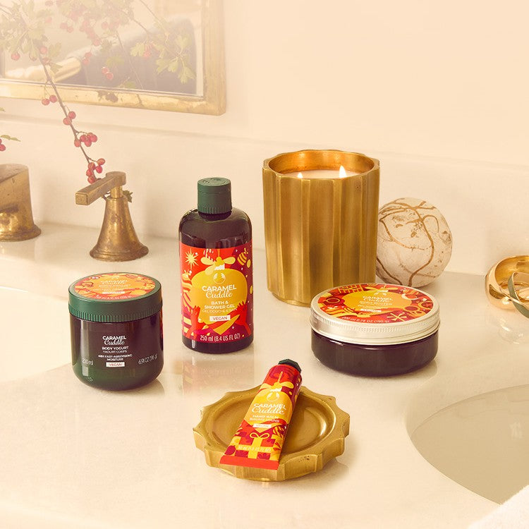 Bathroom counter with skincare products including jars, bottles, and a candle.