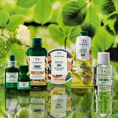 Collection of The Body Shop products with a green leafy background