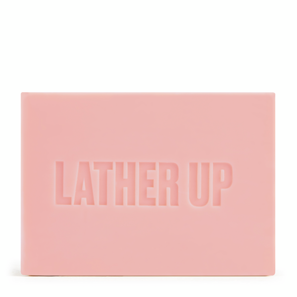 Pink bar of soap with 'LATHER UP' text on a white background