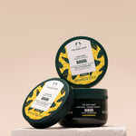 The Body Shop Banana hair mask packaging on a beige background