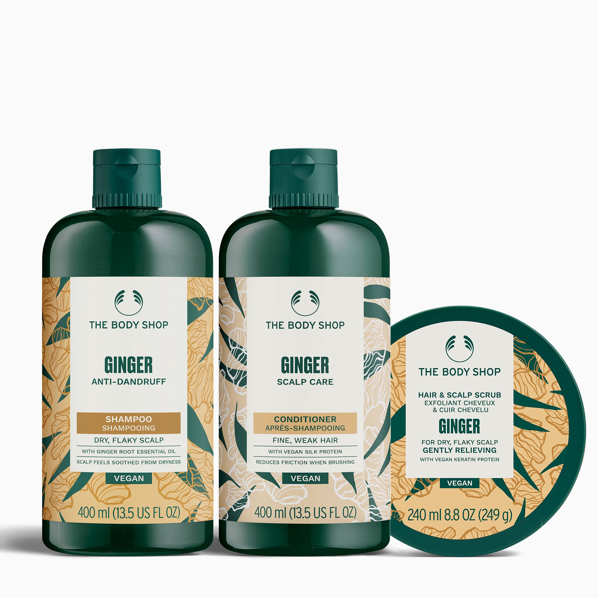 The Body Shop Ginger shampoo bottles of the shampoo, conditioner and scalp scrub on a white background