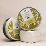 Two containers of The Body Shop Hemp body butter on a beige background