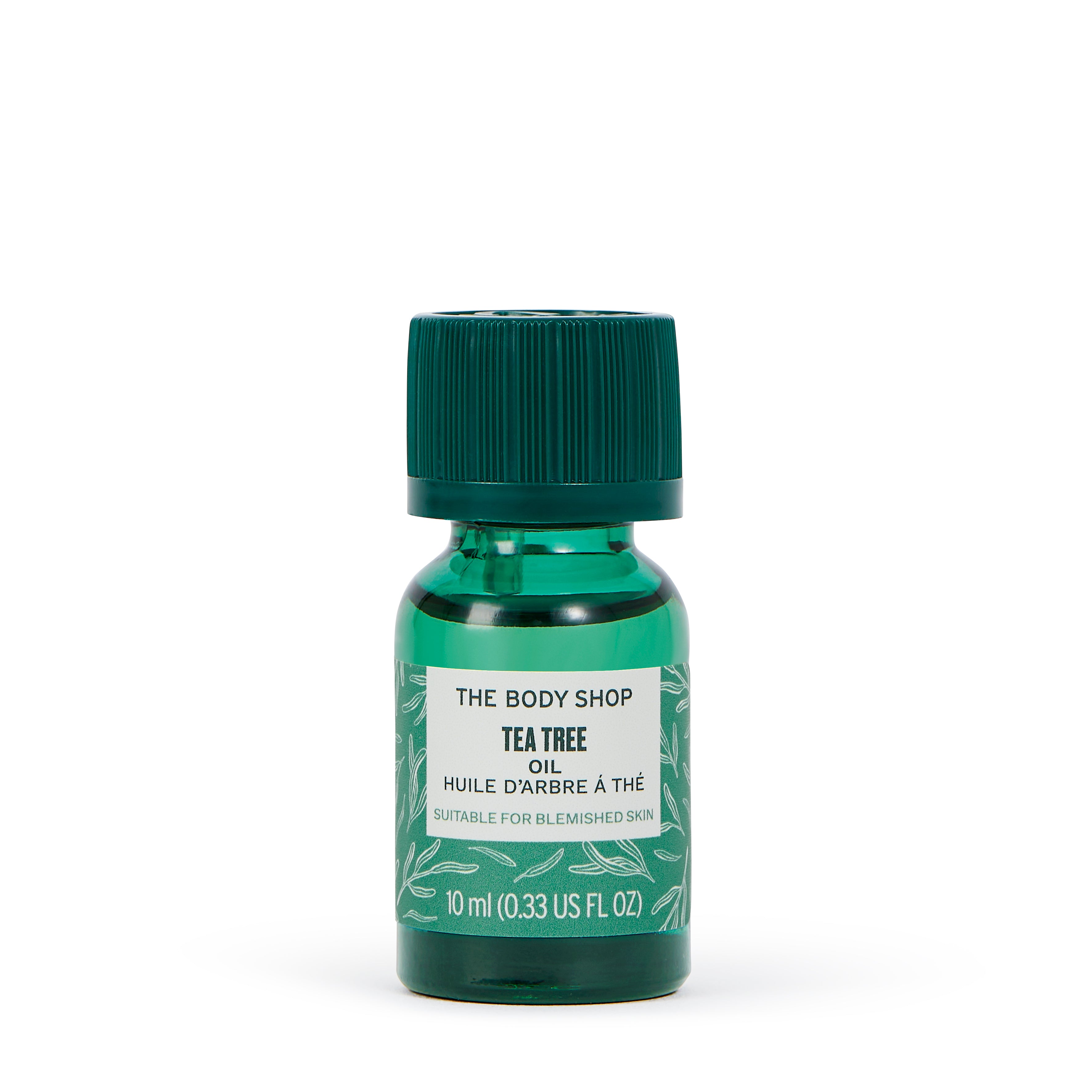 Green bottle of The Body Shop Tea Tree oil on a white background