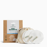 Reusable makeup remover pads with a mesh bag and packaging from The Body Shop on a white background.
