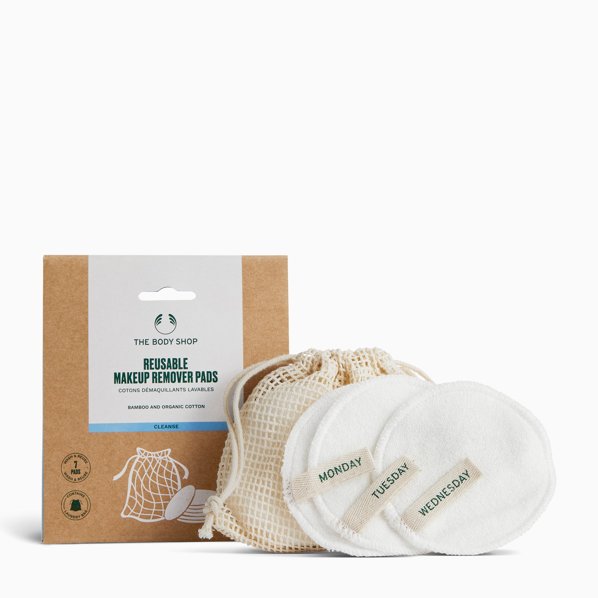 Reusable makeup remover pads with a mesh bag and packaging from The Body Shop on a white background.