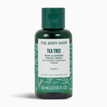 Green bottle of The Body Shop Tea Tree Skin Clearing Facial Wash on a white background