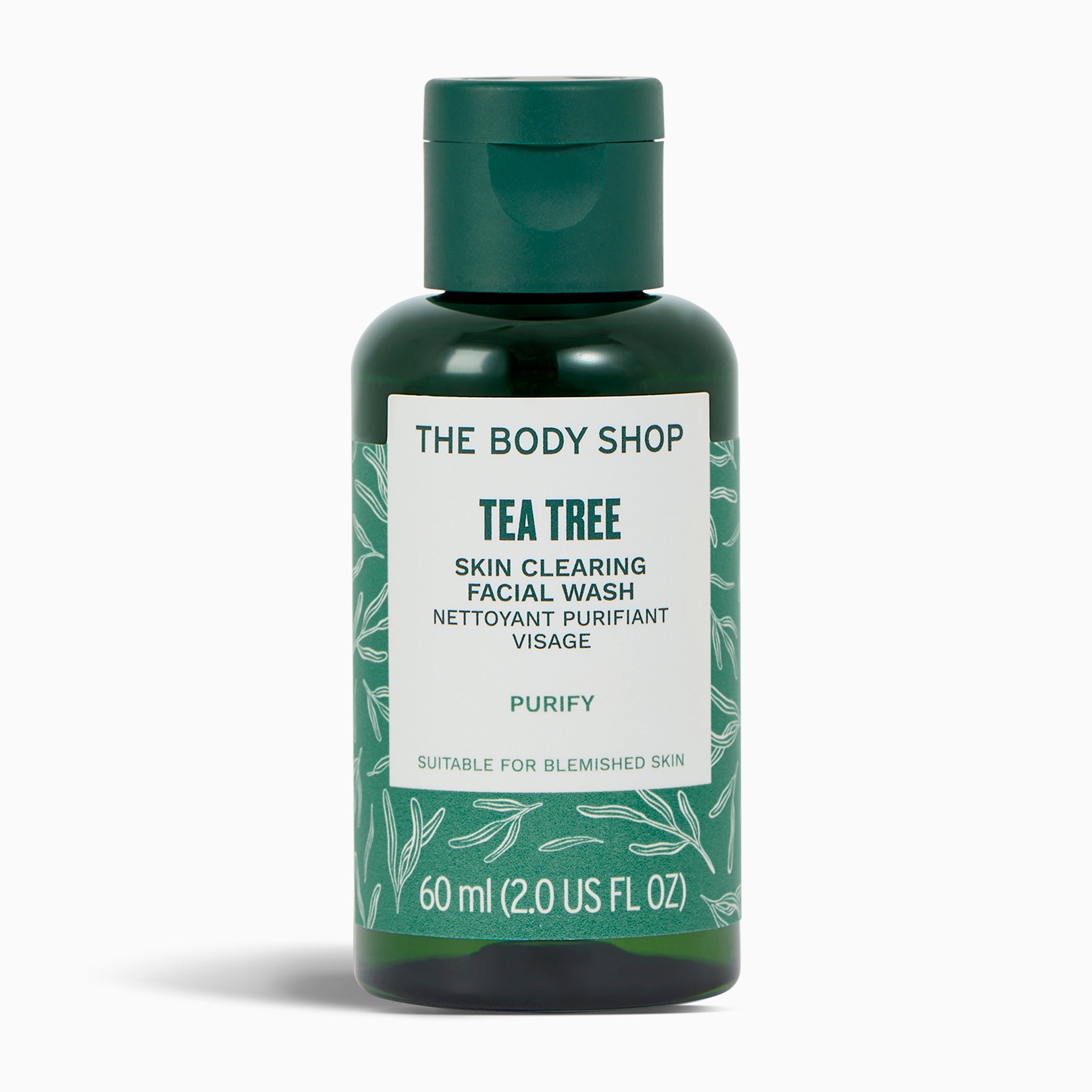 Green bottle of The Body Shop Tea Tree Skin Clearing Facial Wash on a white background