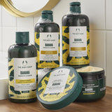 The Body Shop Banana hair care products on a bathroom counter.