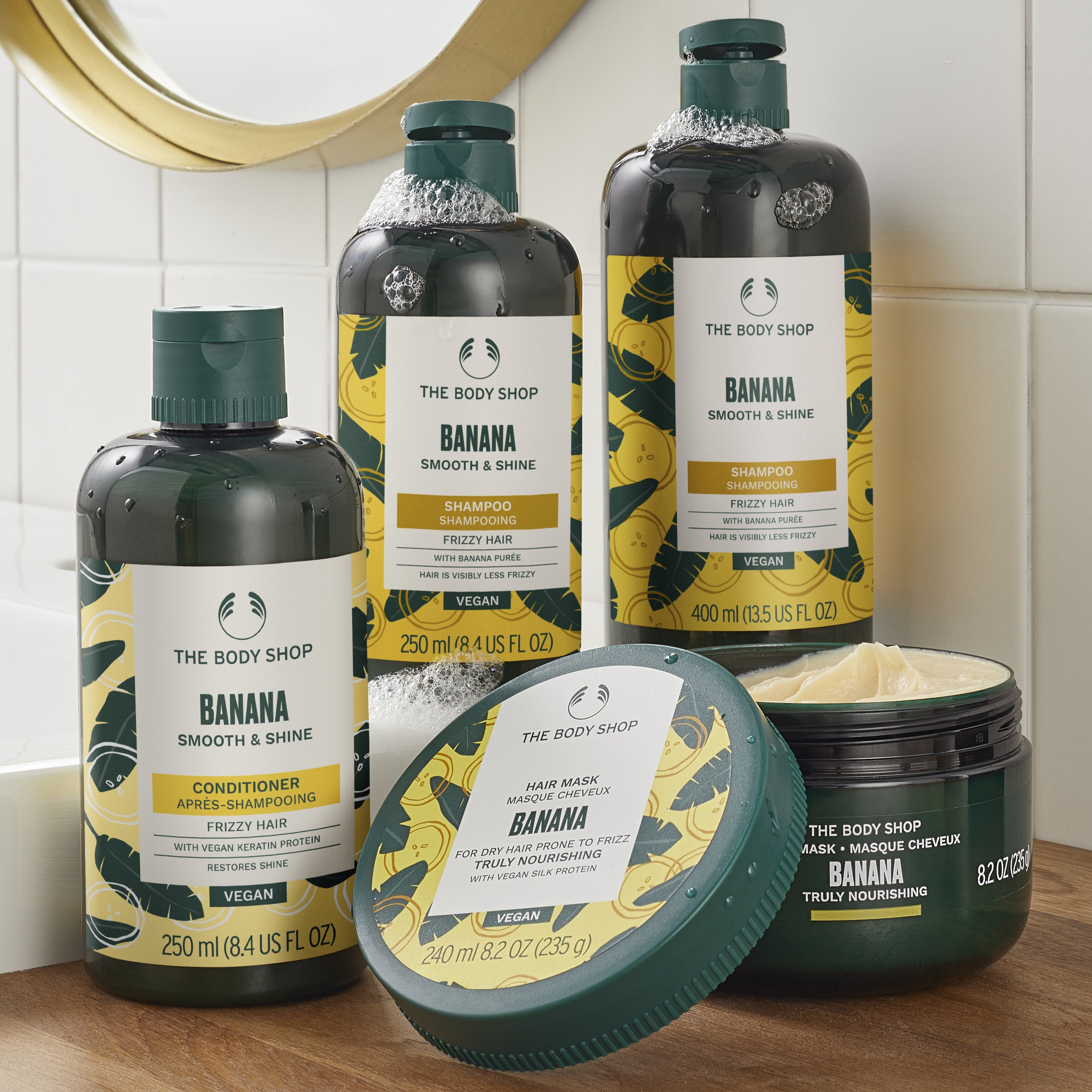 The Body Shop Banana hair care products on a bathroom counter.
