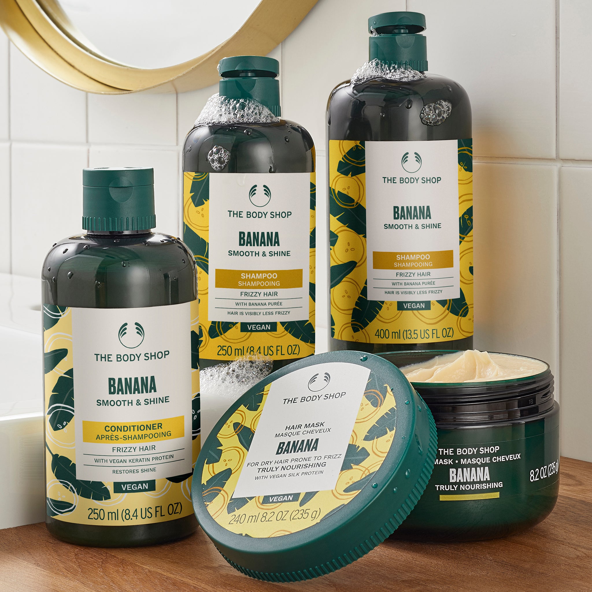 The Body Shop Banana hair care products on a bathroom counter.