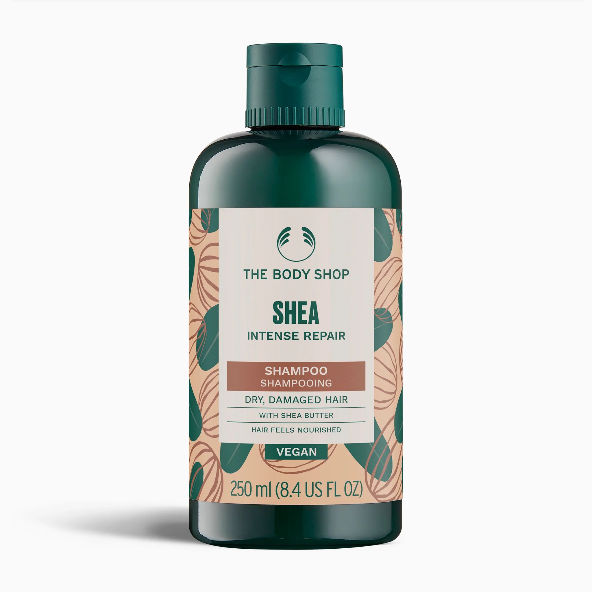 The Body Shop Shea Intense Repair Shampoo in a 250 ml dark green bottle with a white and green label, set against a plain white background.
