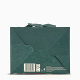 Green envelope packaging with a bow on a white background