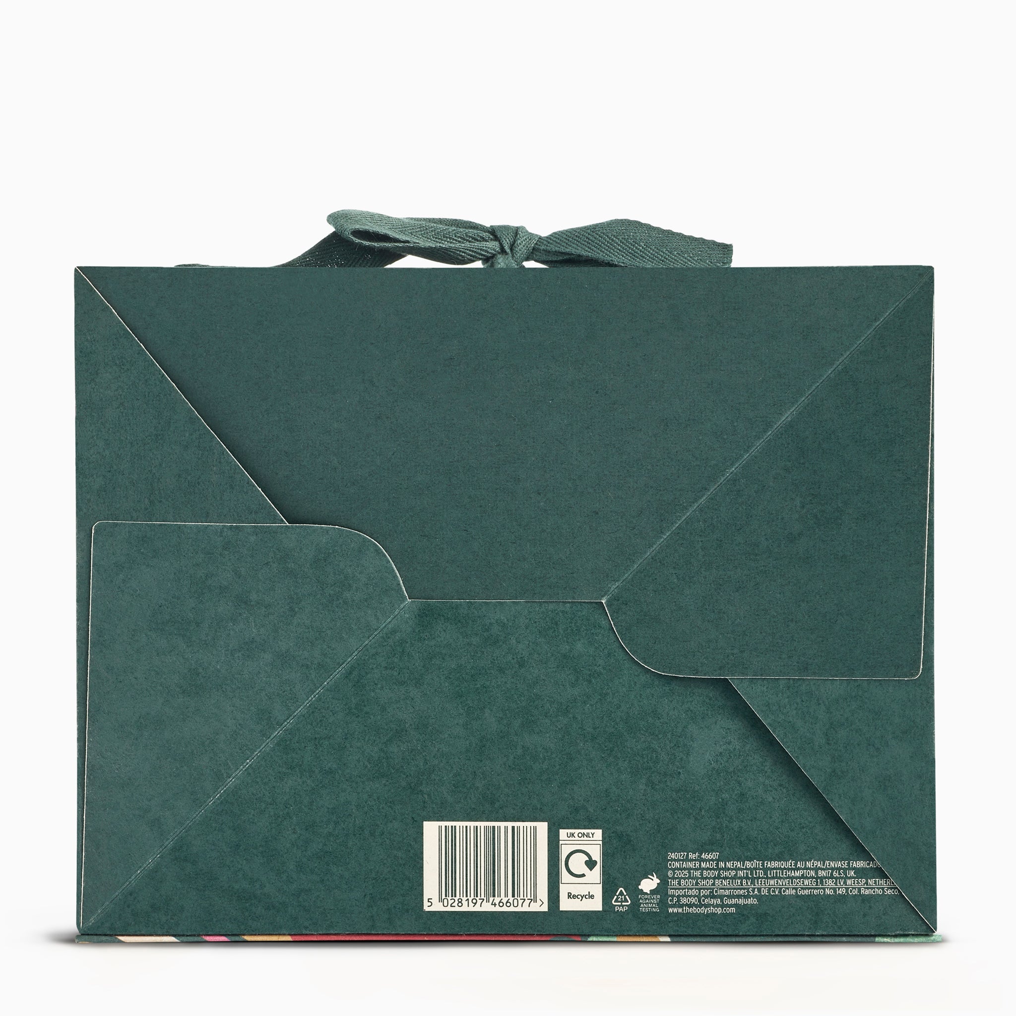 Green paper bag with a bow on a white background