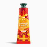Caramel Cuddle hand balm tube on a white background