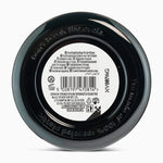 Back of a black jar with text and a barcode on a white background