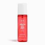 Red perfume mist bottle with white cap and text on a white background