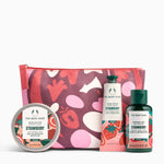 The Body Shop Strawberry product set including a pouch, body butter, hand cream, and shower gel on a white background.