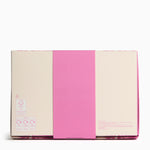 Pink and beige notebook with a visible brand label on a white background