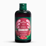 A bottle of The Body Shop Cranberry Shower Gel, featuring a dark green cap and a label with a pink and green cranberry design, set against a plain white background.