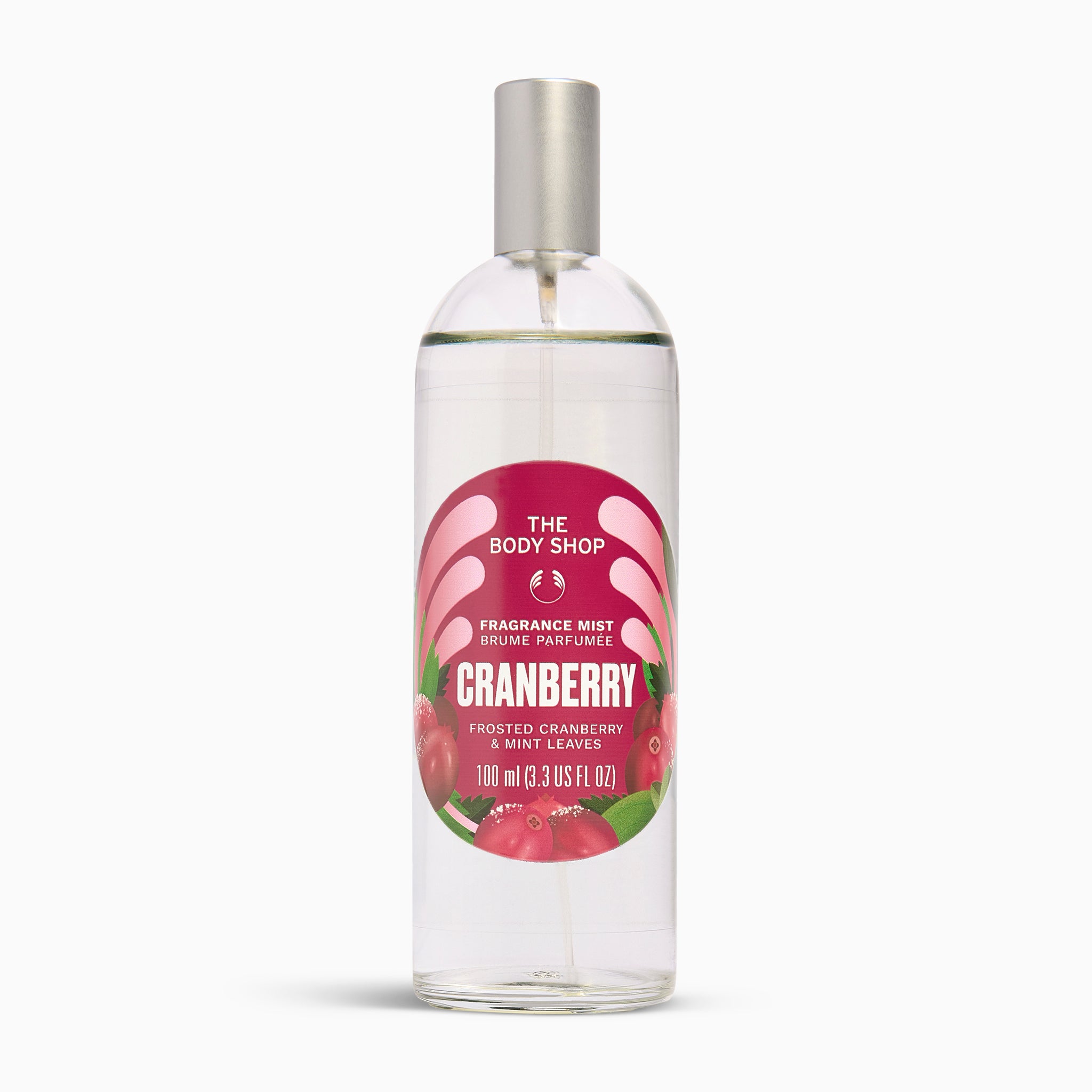 A 100ml bottle of The Body Shop Cranberry Fragrance Mist, featuring a clear bottle with a silver spray cap and a red and pink label with illustrations of cranberries, set against a plain white background.