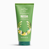 A 200ml squeeze tube of The Body Shop Matcha Body Lotion 10-D Milk, featuring a green design with white text and illustrations of matcha leaves and yellow chocolate swirls, set against a plain white background.