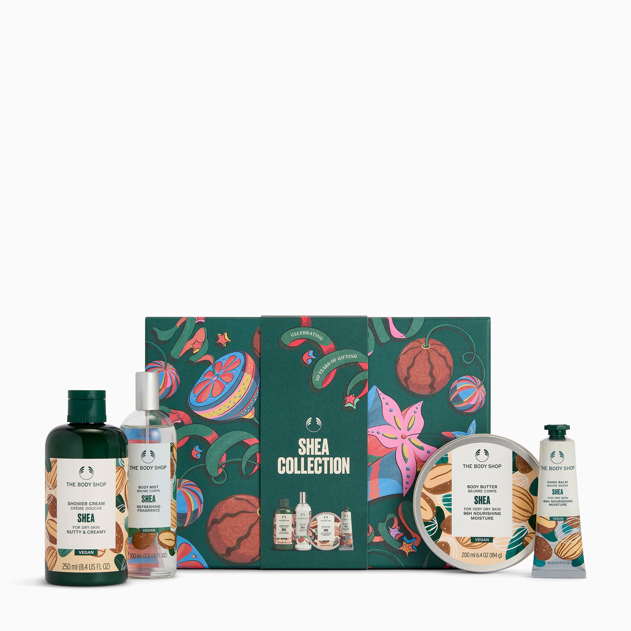 The Body Shop Shea Collection gift set featuring a dark green illustrated box with botanical and fruit motifs, surrounded by matching Shea products including a shampoo bottle, shower gel bottle, body wash bottle, hand cream jar, and hand cream tube on a white background.
