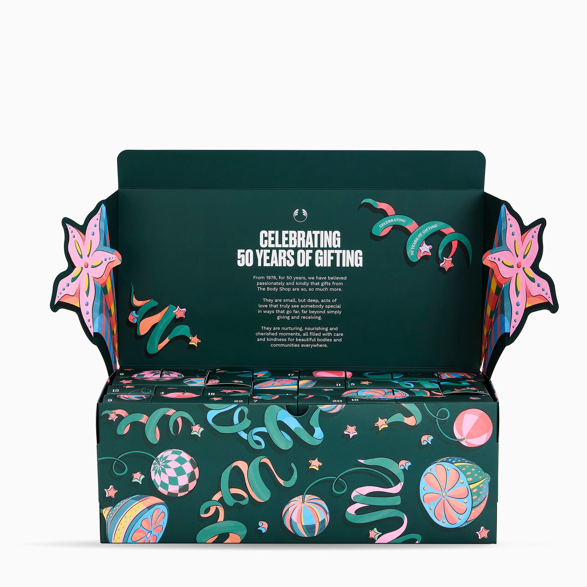 An open dark green gift box with decorative multicolor illustrations and the text 'CELEBRATING 50 YEARS OF GIFTING' on the inside lid, shown on a clean white background.
