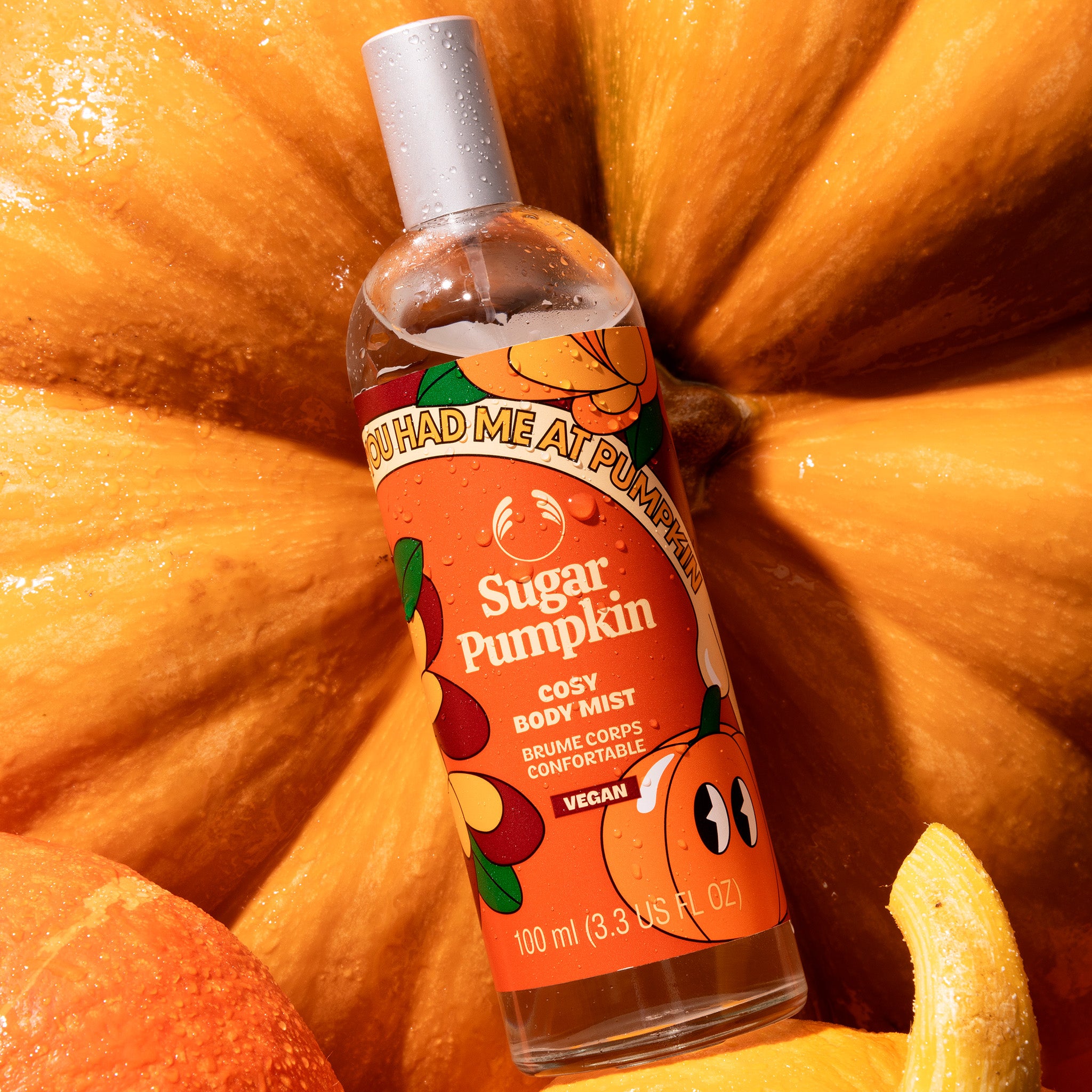 Bottle of 'Sugar Pumpkin' body mist surrounded by pumpkins