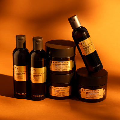 Spa of the World skincare products on an orange background