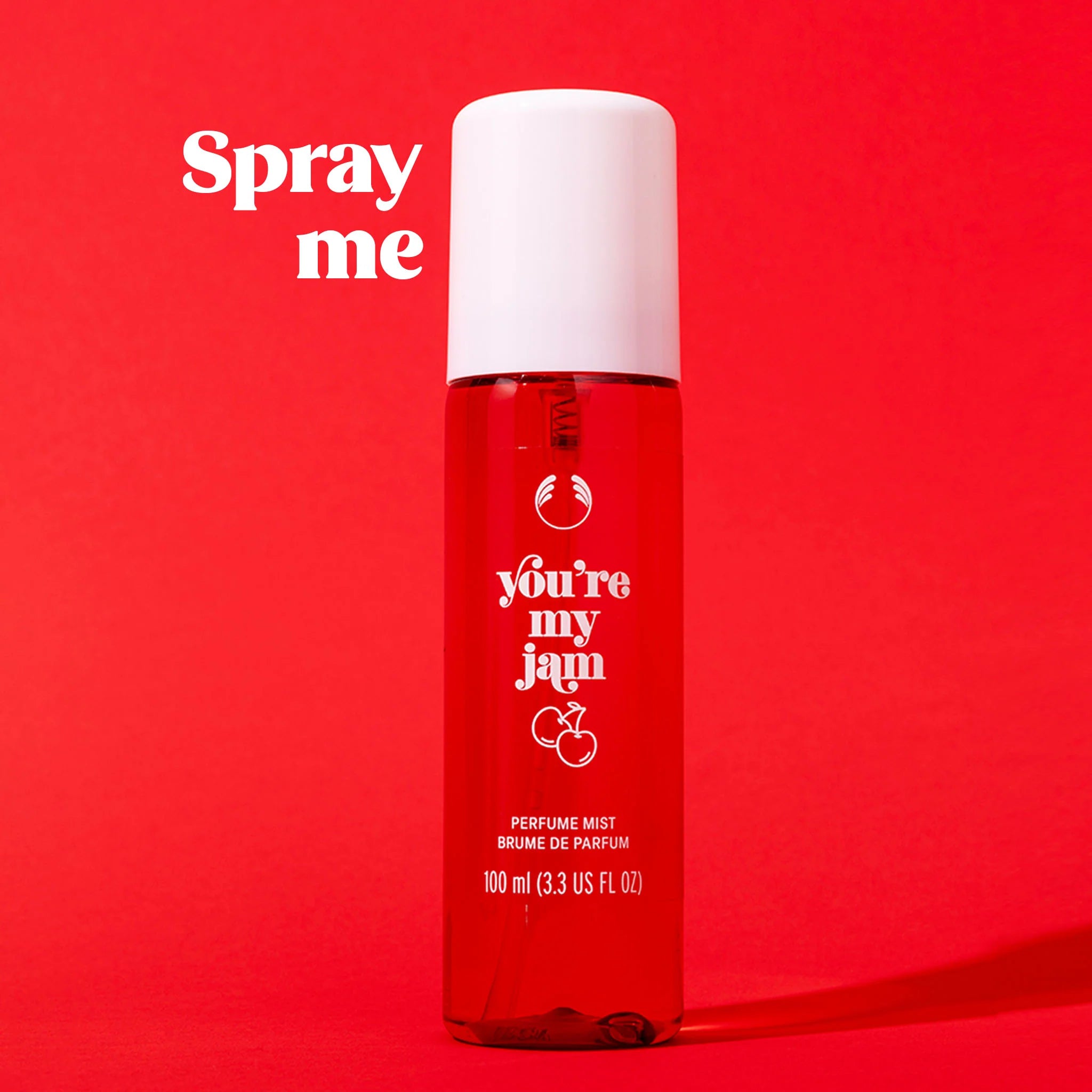 Red perfume mist bottle with white cap on a red background, featuring the text 'Spray me' and 'you're my jam'.