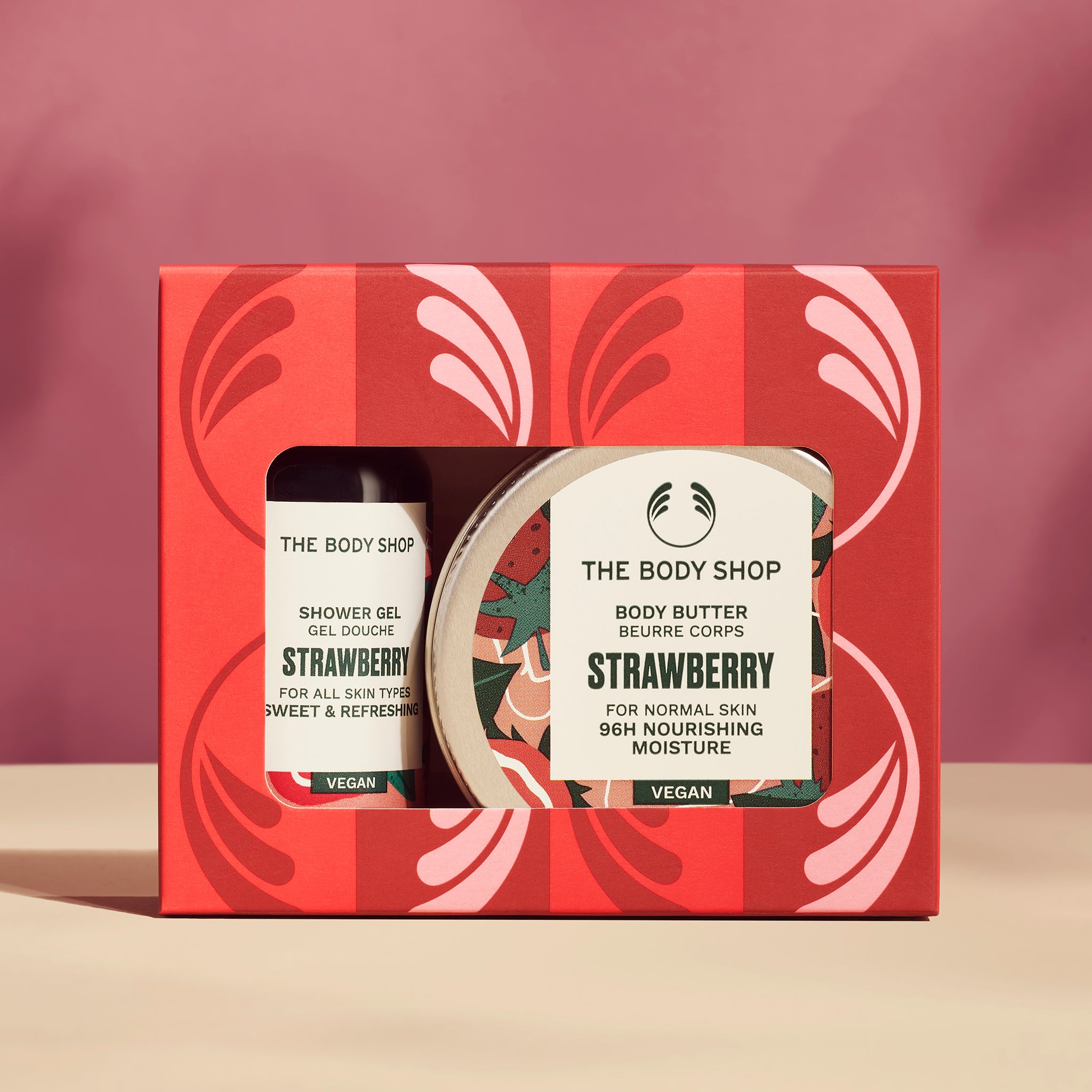 The Body Shop Strawberry product set in a red box with a pink background