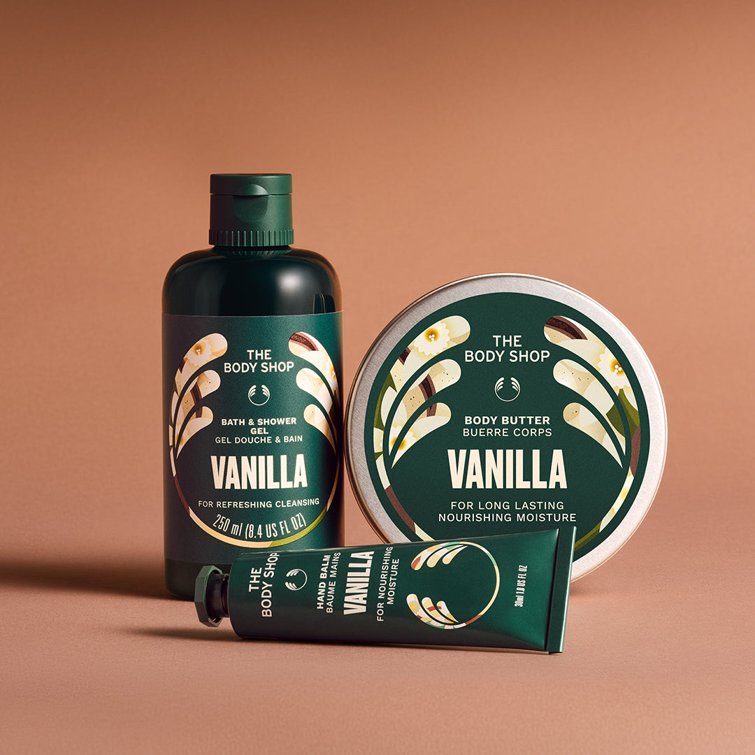 The Body Shop Vanilla products including a bottle, tube, and tin on a brown background