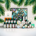 Collection of skincare products with decorative box and green leaves on a white background