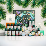 Collection of skincare products with decorative box and green leaves on a white background