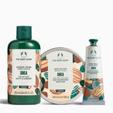 The Body Shop Shea product set including shower cream, body butter, and hand balm on a white background