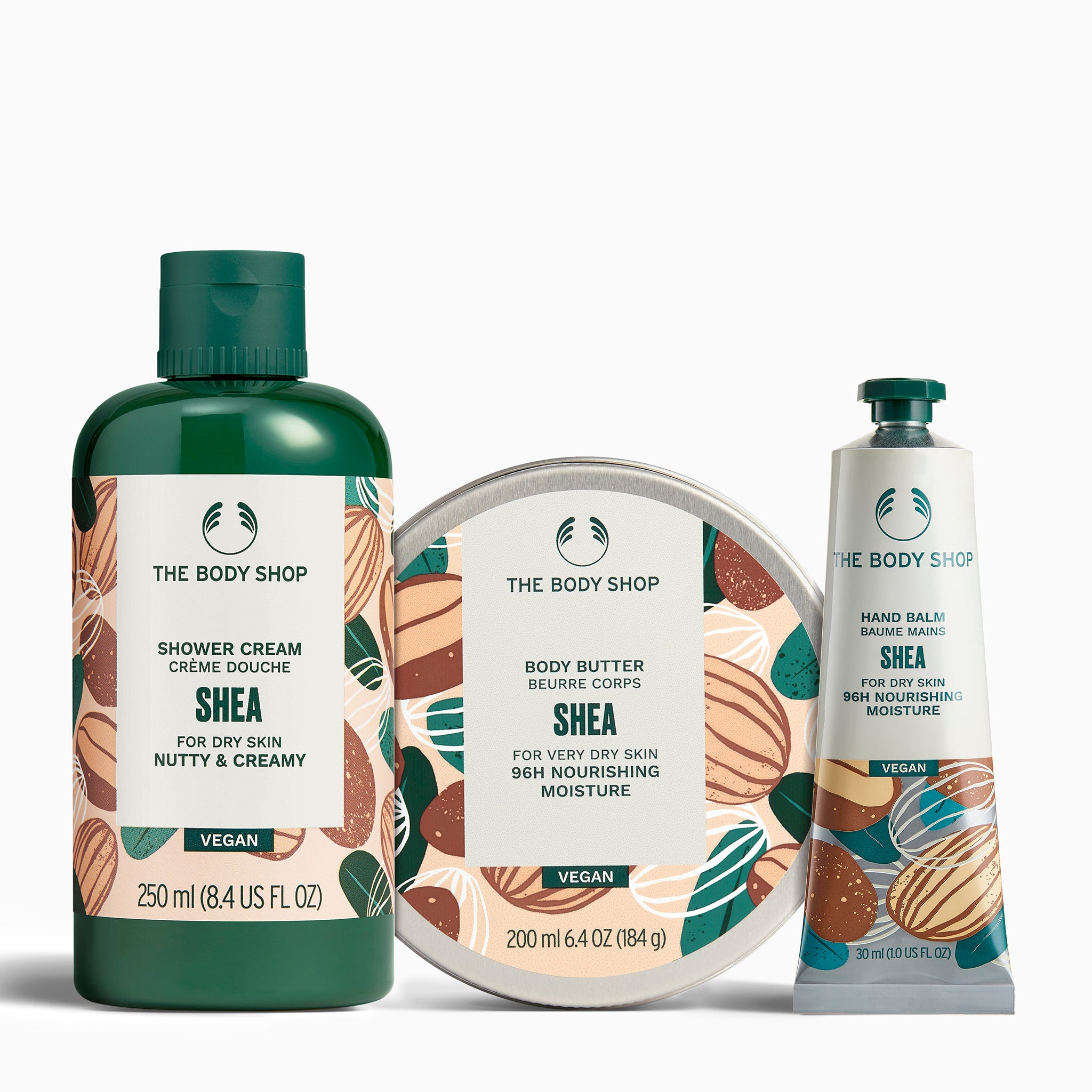 The Body Shop Shea product set including shower cream, body butter, and hand balm on a white background