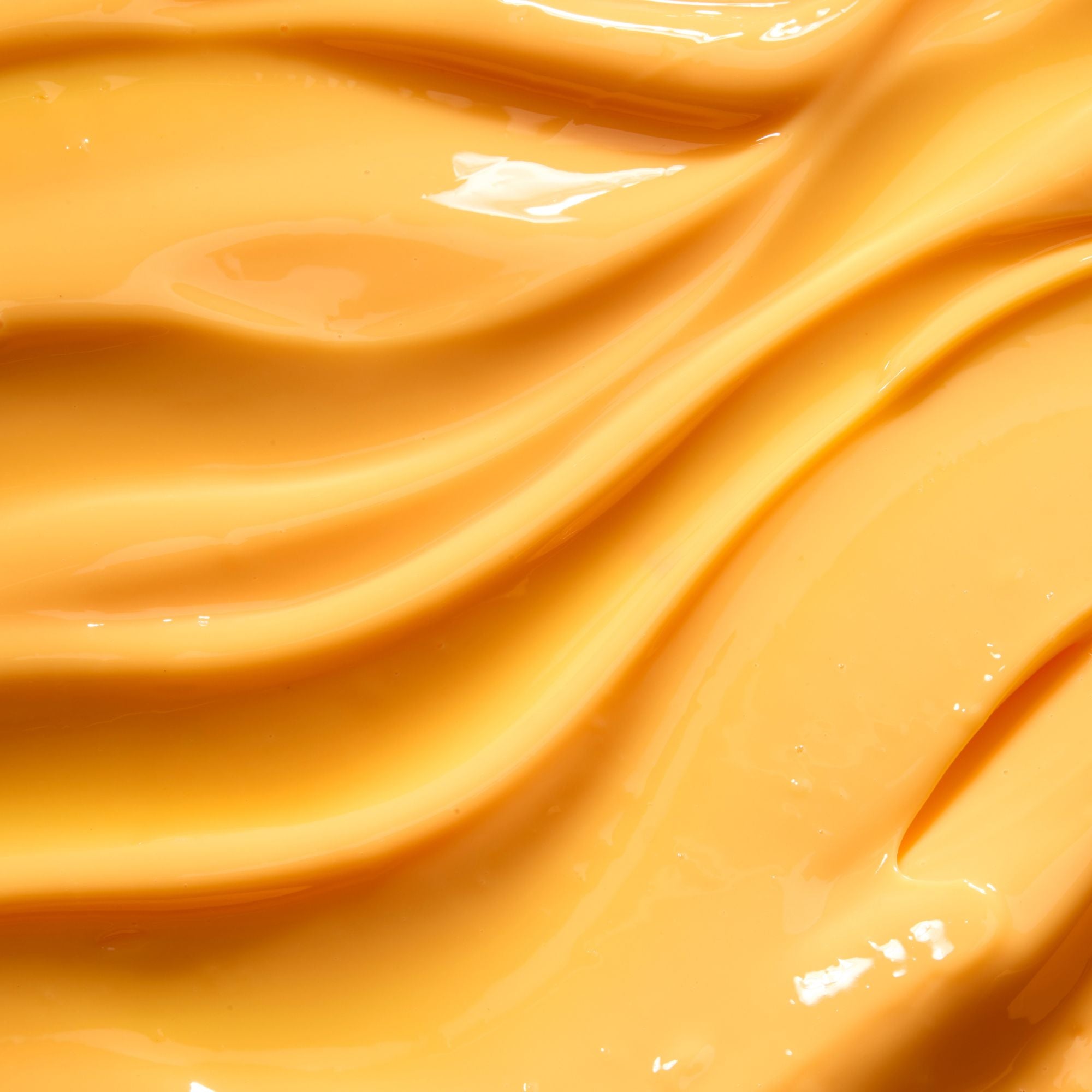 Close-up of smooth, glossy beige-colored lip balm