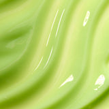 Close-up of smooth, glossy green surface with reflections