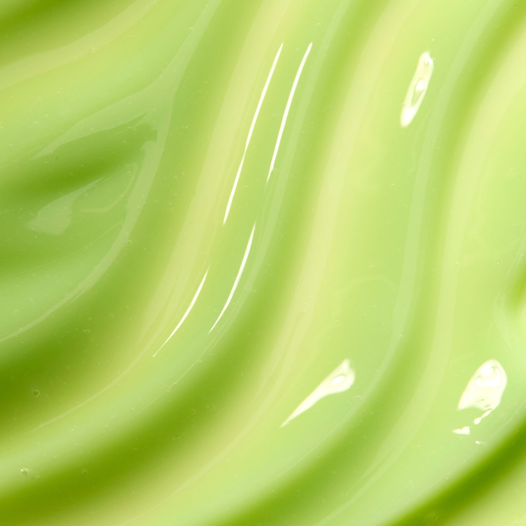 Close-up of smooth, glossy green surface with reflections