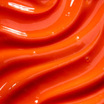 Close-up of smooth, orange- red coloured glossy lip gloss