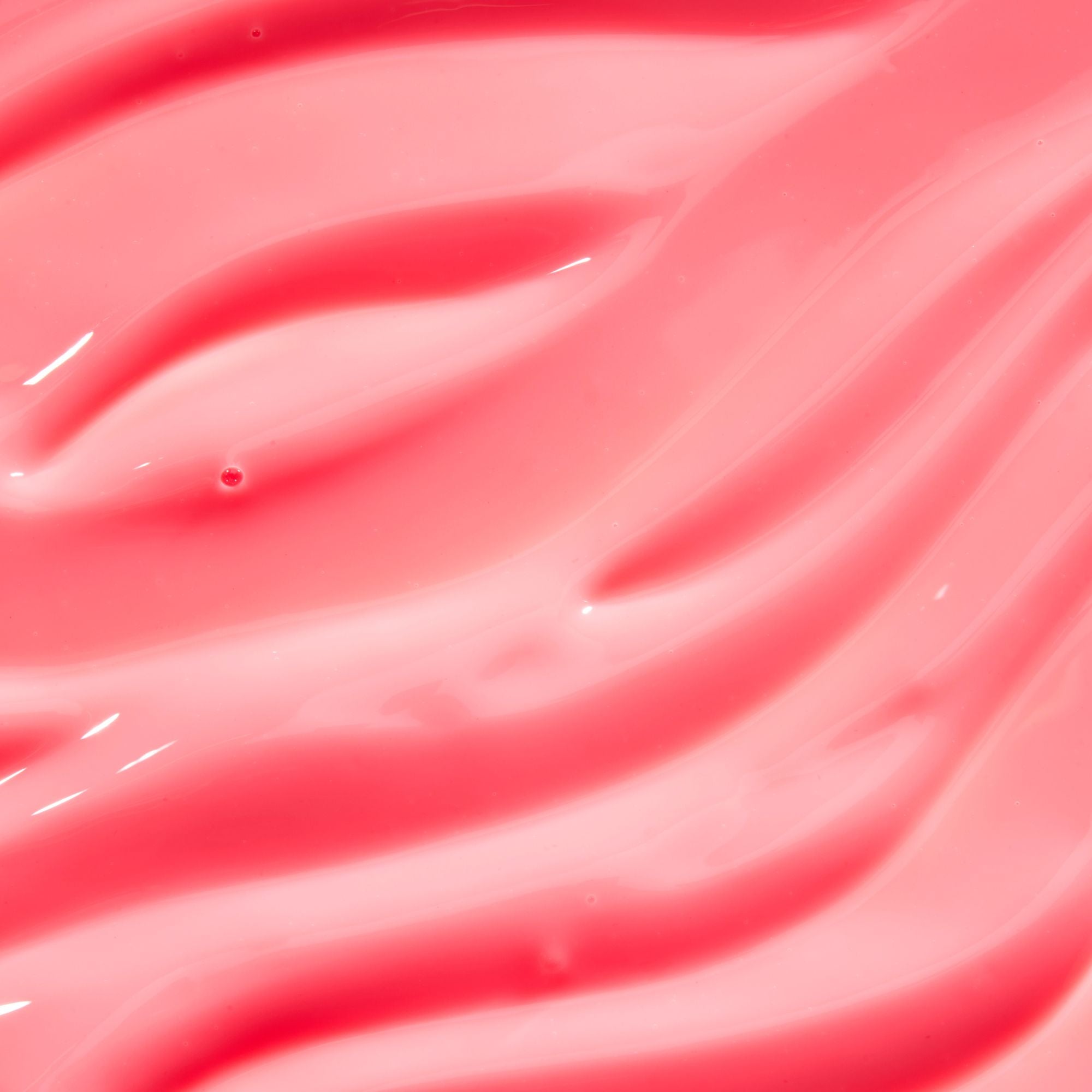 Close-up of pink, glossy lip balm.
