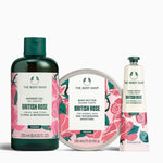 The Body Shop British Rose product set including shower gel, body butter, and hand cream on a white background.